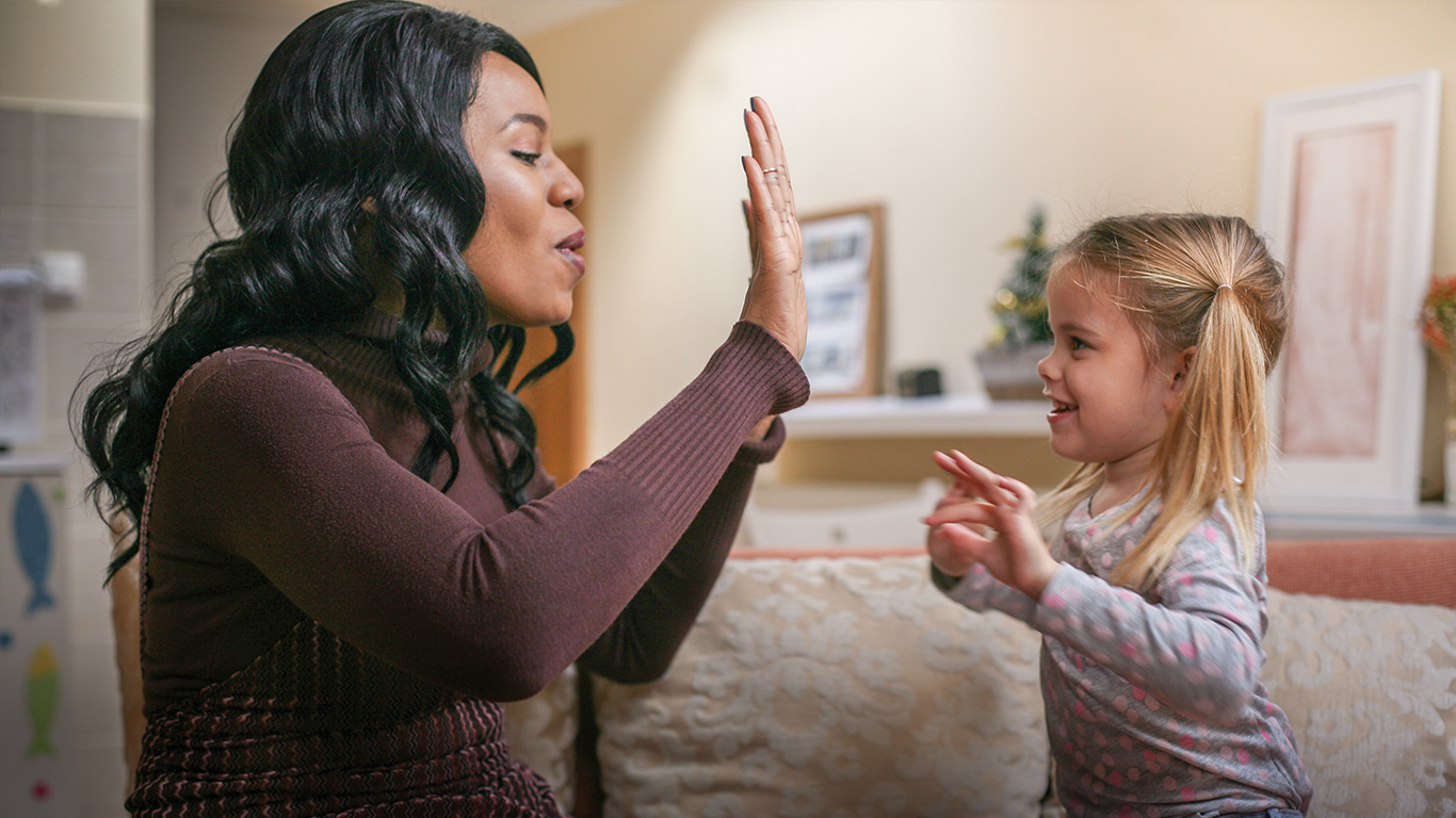 GAL volunteer woman with child high fiving