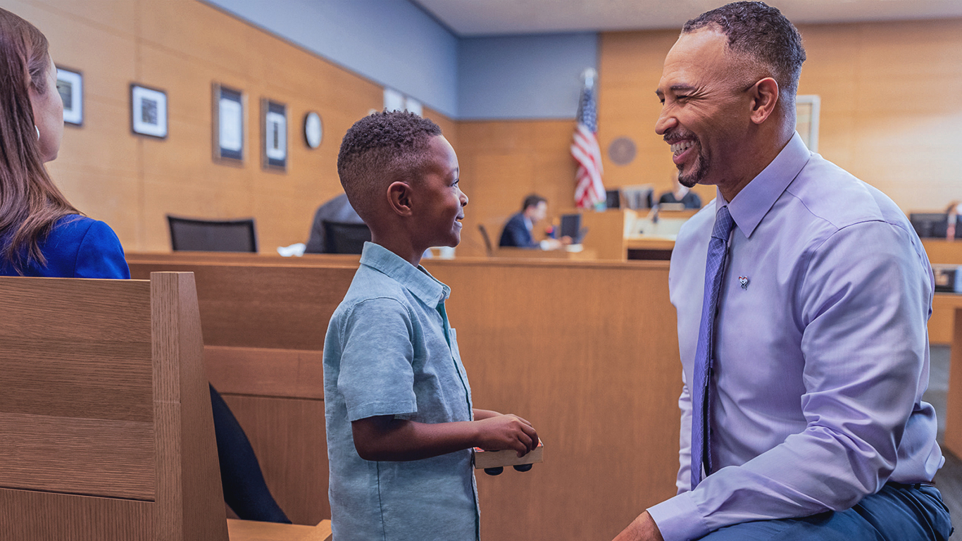 GAL man with child smiling in courtroom