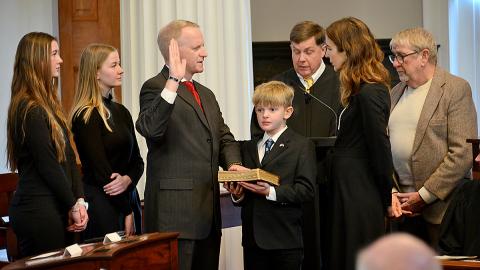 Tom Murry (center) receives the oath of office